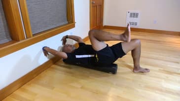 Dead bug on foam roller for rotatory stability