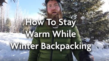 How To Stay Warm While Winter Backpacking (Layering Techniques & Pro Tips)