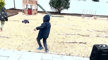 Kids having fun with the DEERC DE60 Large 1:8 Scale Upgraded Remote Control Truck outdoors