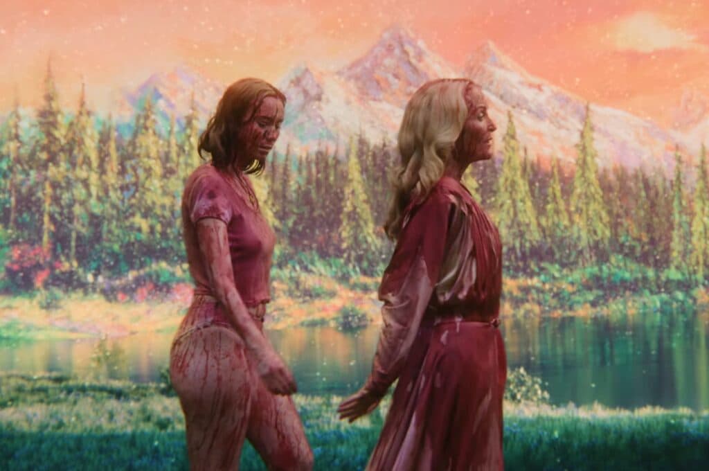 A blood-soaked Gillian Anderson leads a memorized-looking blood-soaked Hannah Einbinder, in her underwear, through a pastel lakeside landscape in Teenage Sex and Death at Camp Miasma