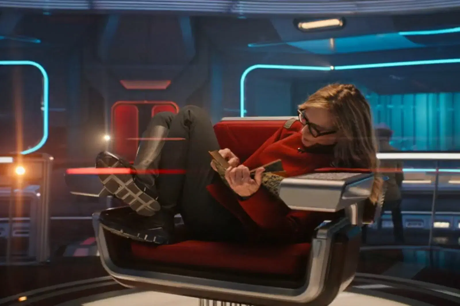 Captain Nahla reading in the cpatain's chair