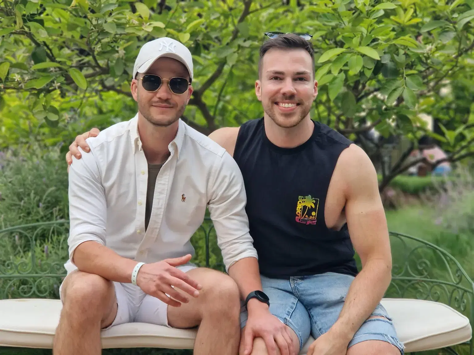 Kyle and Adam sitting together on a bench