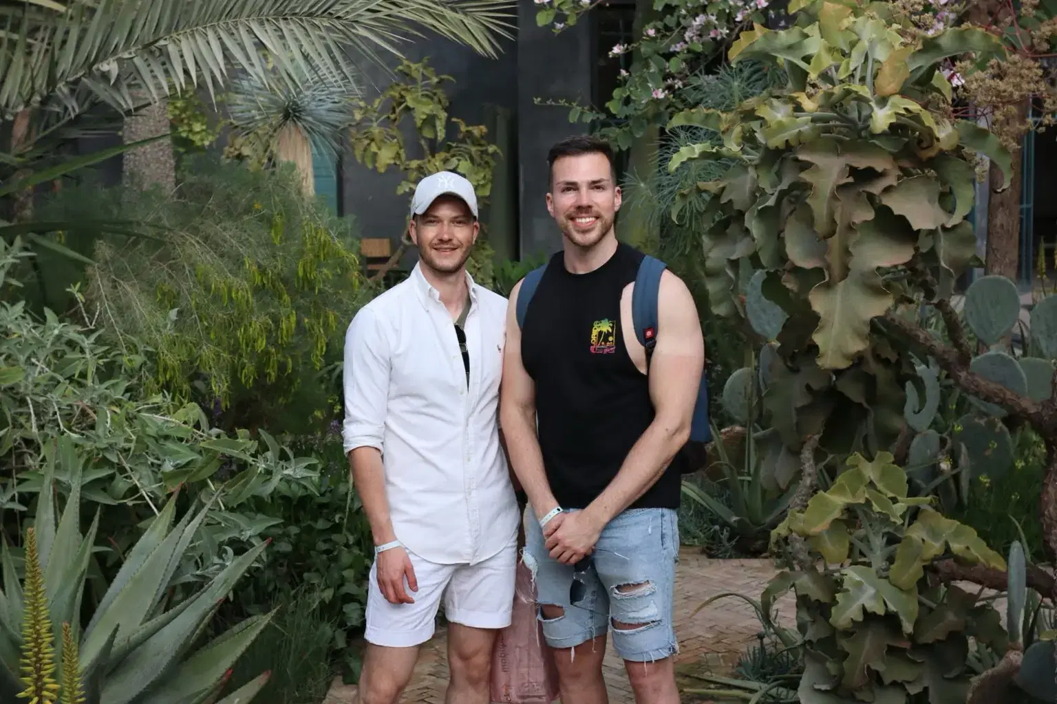 Kyle and Adam standing together in a garden