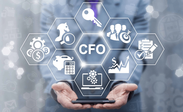 A CFO holding a digital dashboard with icons for cash, strategy, analytics, and operations, representing the many responsibilities of a new CFO in their first 90 days.