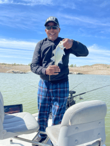 Jimmie D King holding a fish he caught at Elephant Butte Reservoir