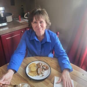Lori Ann King eating fish Jimmie King prepared, that they caught fresh at Elephant Butte Reservoir