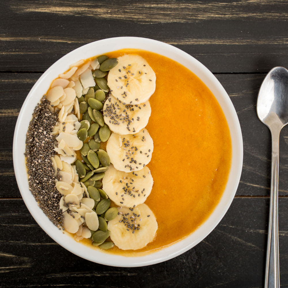 Festive pumpkin smoothie bowl for a Halloween-themed snack