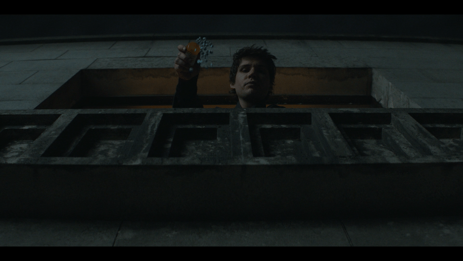 Man dropping pills out a window