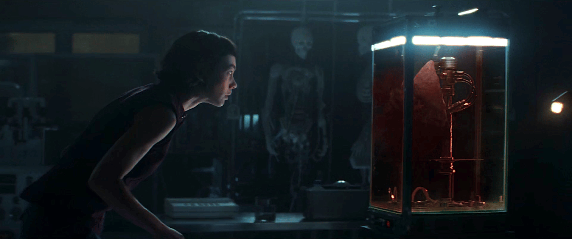 Screen capture from episode four of alien Earth, showing the character Wendy looking at a specimen tank