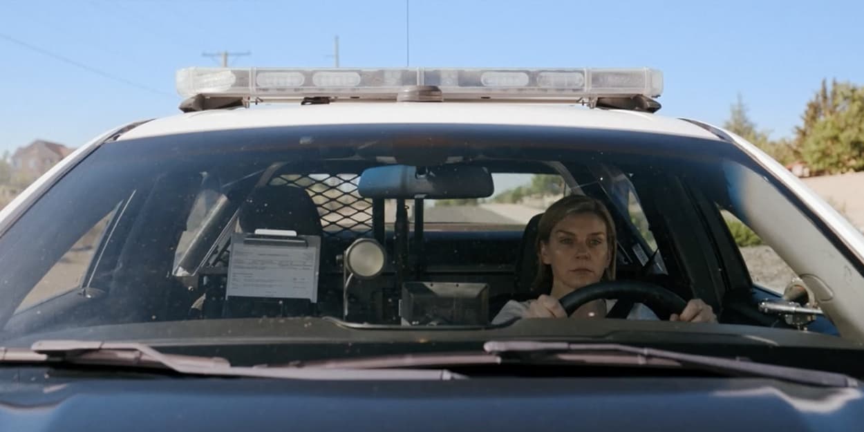 Carol Sturka, played by Rhea Seehorn, drives a police car in episode 5 of Pluribus on Apple TV