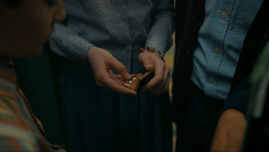 Kids holding pill box with small white pills in it