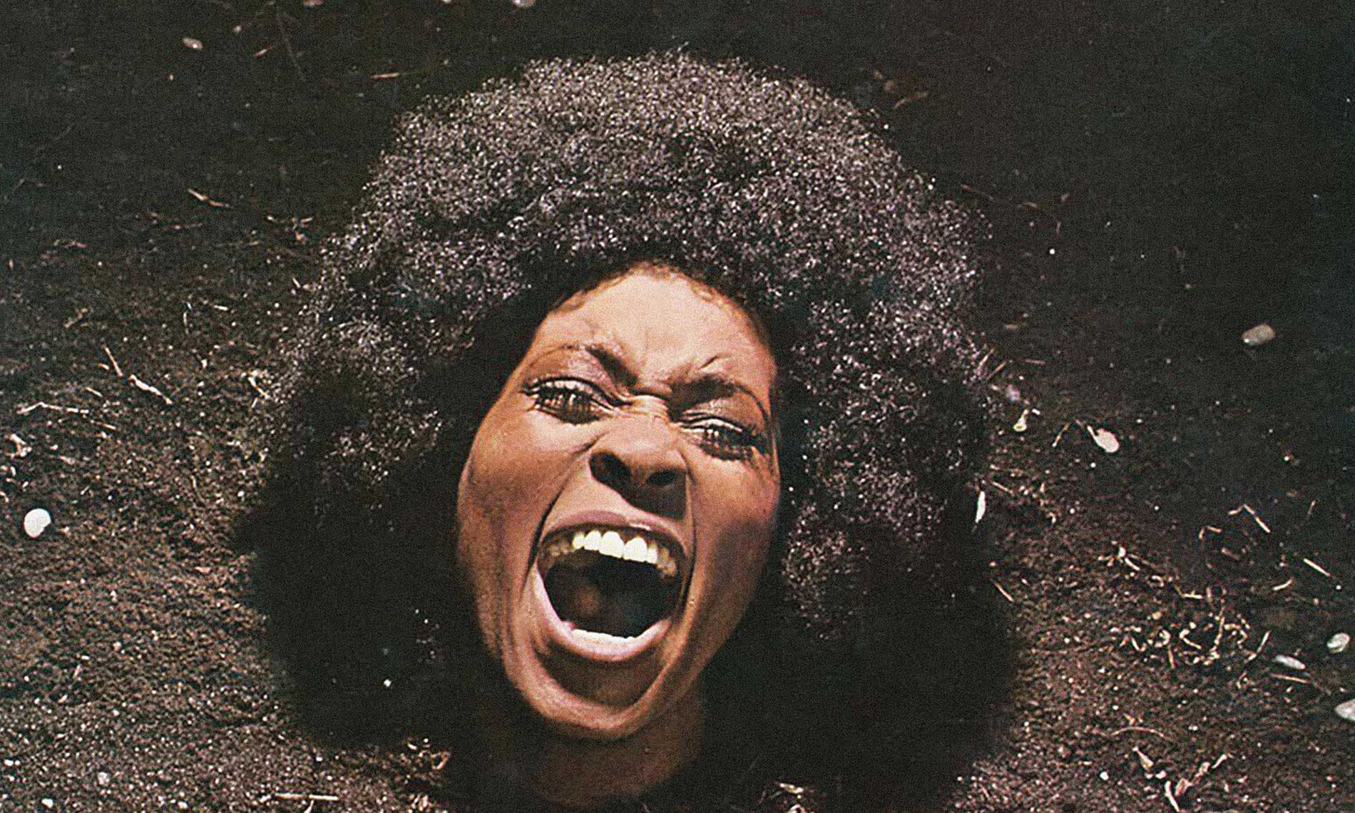 Cover art from the 1971 album, Maggot Brain, by Funkadelic. Image shows a woman's head apparently, coming out of the soil with an expression on her face that suggests a scream