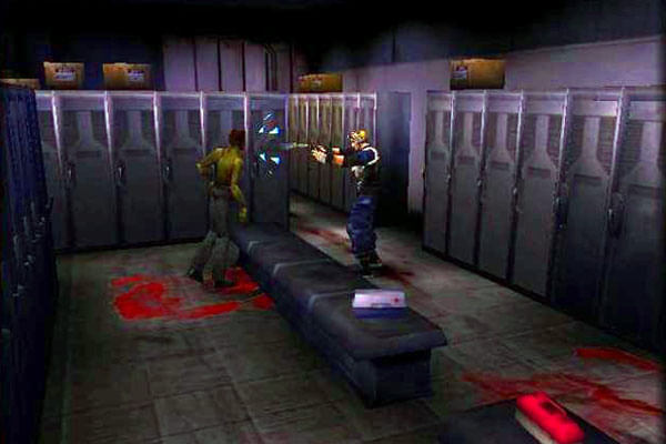 **Alt Text:** A low-resolution screenshot from a 3D video game shows a tense scene in a dimly lit locker room. One character in a blue uniform aims a gun at another character in a yellow shirt, who appears to be staggering backward. Bloodstains are visible on the floor near the benches and lockers, contributing to a grim atmosphere.