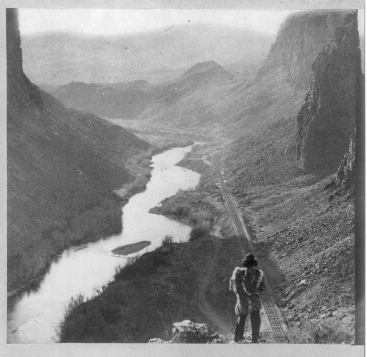 picture of American Indian looking at railroad track