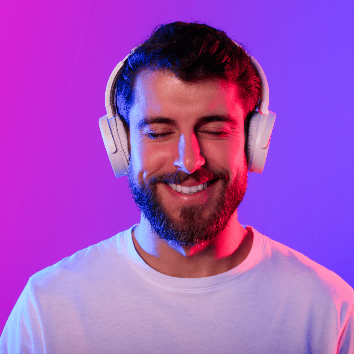 smiling man listening to podcast