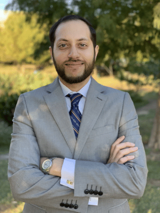 Dr. Omar Akhter standing with arms crossed
